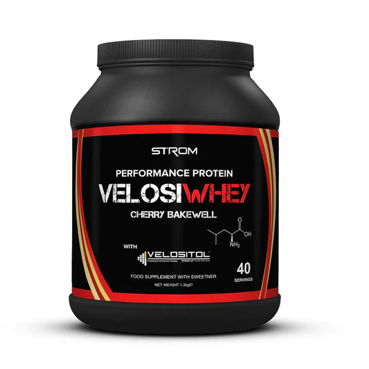 A container of Strom Performance Protein VelosiWHEY Cherry Bakewell flavour with 40 servings. The container is black and red with the product name and flavour clearly displayed.