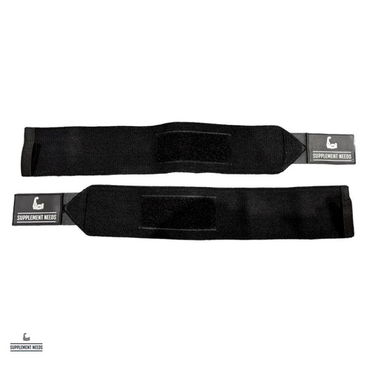 A pair of black wrist wraps with a label showing the brand name 'Supplement Needs'.